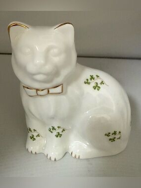 White Ceramic Cat Figurine with Green Clover Accents and Gold Trim